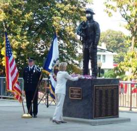 Congresswoman Shelly Moore Capito places a flower at the foot of the Fallen Fire Fighterâ€™s Memorial at the WV State Capitol Complex.